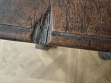 a close up of a wooden table with peeling paint on it