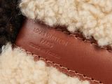 a close up view of a sheep ' s wool and leather jacket