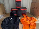 une pile de cartons sur laquelle sont posées une paire de genouillères