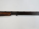 a shotgun with a wooden barrel on a white background