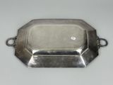a silver tray with a chain around it on a table
