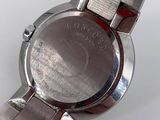 an image of a close up of a wrist watch on a white surface