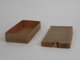 two boxes that are sitting on a white surface