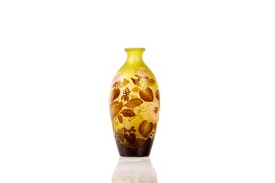 a yellow vase that is sitting on a white surface