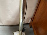 a lamp that is sitting on the floor next to a bed