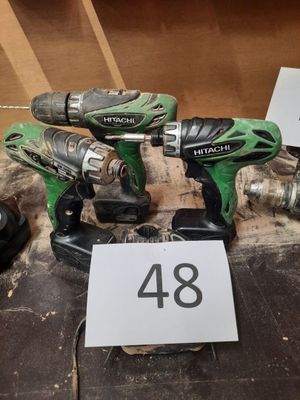two cordless drillets are sitting on a table with a price tag