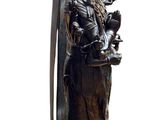 statue of a woman holding a surfboard on a pedestal