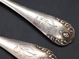 two spoons that are sitting next to each other
