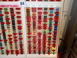 a lot of different colors of thread on a rack