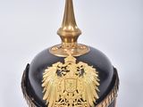 a black and gold helmet with a gold eagle on it