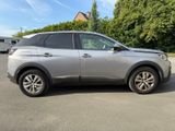 a picture of a silver suv parked in a parking lot