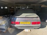 a car that is parked in a garage next to other cars