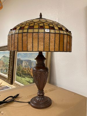 a lamp that is sitting on a table next to a picture