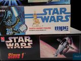 three star wars action figures on display in a display case
