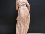statue of a woman holding a flower in her right hand