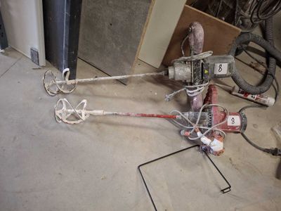 a picture of a broken drill and other tools on the floor