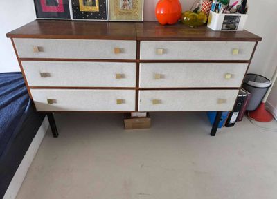 a white dresser with a wooden top in a room
