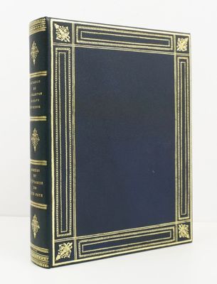 a blue book with gold trimming and a black cover