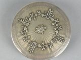an image of a silver plate with a floral design on it