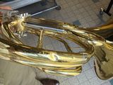 a man holding a brass instrument in his hand