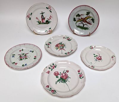 several plates with flowers and birds on them on a white surface