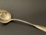 a silver spoon with a picture of a woman on it