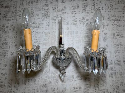 two wall sconces that are attached to a wall