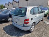 a silver car parked in a parking lot next to other cars