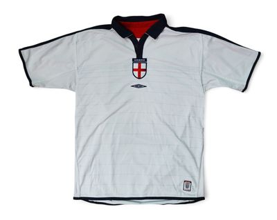 the shirt is white and black with a red and white crest on it