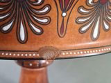 a cake on a wooden stand with a decorative design on it