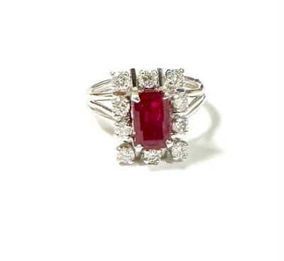 an image of a ring with a red stone surrounded by white diamonds