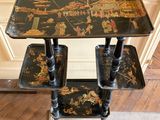 a black table with three trays on top of it