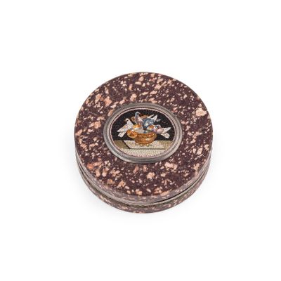 a small round box with a picture of a man on it