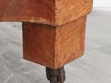 a close up of a wooden table with wheels on it