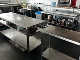 a large kitchen with stainless steel counter tops and stainless steel shelvings