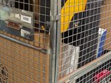 boxes stacked on top of each other in a metal cage