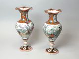 two vases that are sitting on a table