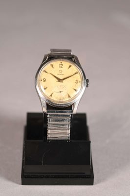a watch that is sitting on a stand on a table