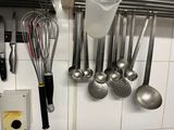 a lot of utensils hanging on the wall