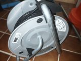 a cable reel that is sitting on a tile floor