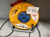 a yellow cable reel that is connected to a red and black cord