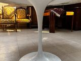 a white table with a marble top in a living room