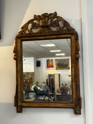 a mirror hanging on the wall in the corner of a room