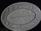 a white plate with a stick in it on a table