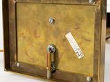 a metal box with a screw and a wooden handle on it