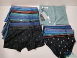 three pairs of men ' s underwear sitting on top of a table