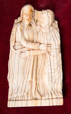 an image of a carving of a woman holding a child