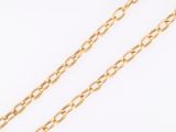 a close up of a gold chain on a white background
