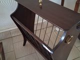 a wooden table with a magazine rack on top of it