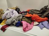 a pile of clothes sitting on top of a white counter